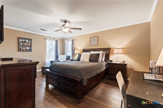 bedroom with dark wood-style flooring, visible vents, and crown molding