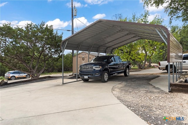 view of parking featuring a storage unit, concrete driveway, and a carport