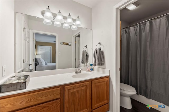 bathroom featuring toilet, ensuite bath, vanity, and a shower with curtain