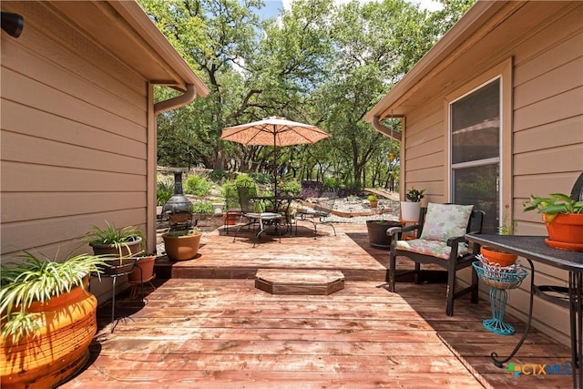 wooden deck featuring outdoor dining space