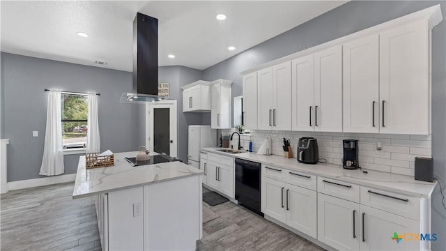 kitchen featuring white cabinets, a sink, black dishwasher, island exhaust hood, and a center island with sink