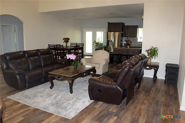 2805 Tumbleweed Trl, Dale, TX 78616 - living room with dark wood-style floors, plenty of natural light, and arched walkways