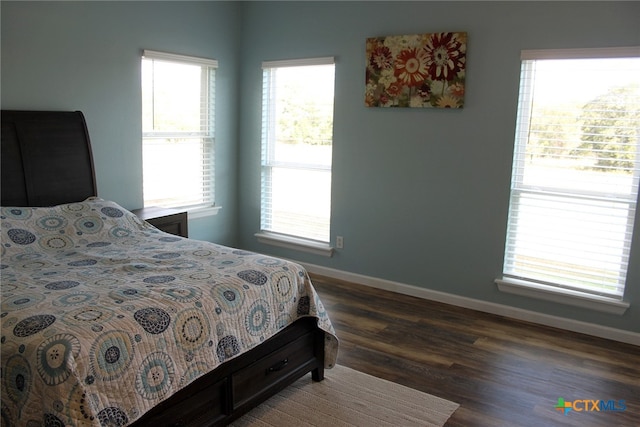 bedroom with dark wood-type flooring