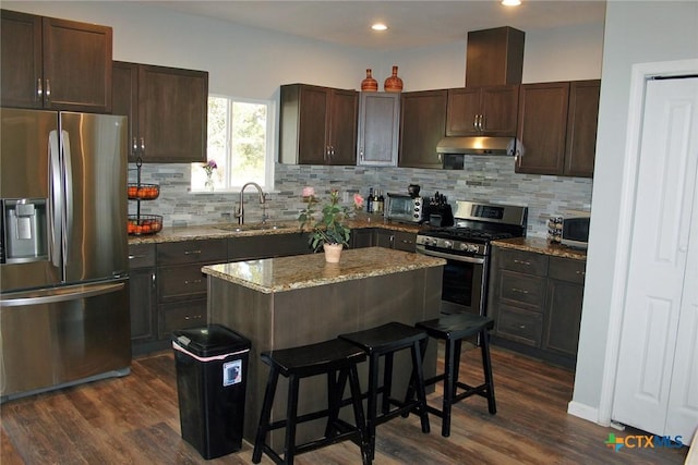2805 Tumbleweed Trl, Dale, TX 78616 - kitchen featuring appliances with stainless steel finishes, under cabinet range hood, dark brown cabinets, and recessed lighting