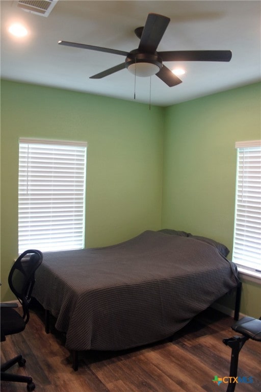 bedroom featuring ceiling fan and dark hardwood / wood-style floors