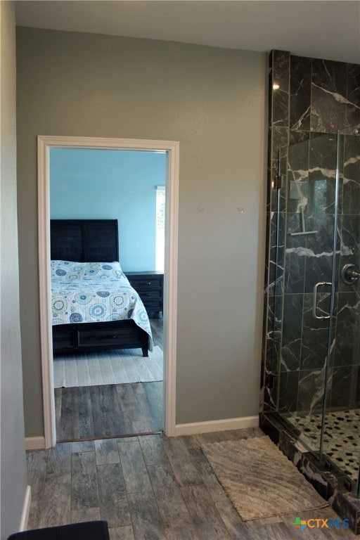 bathroom featuring walk in shower and hardwood / wood-style flooring