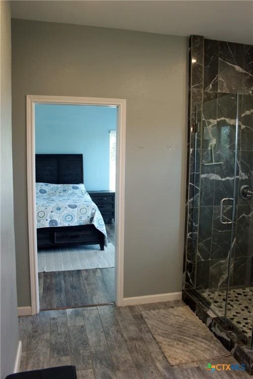 2805 Tumbleweed Trl, Dale, TX 78616 - bathroom with a marble finish shower and wood finished floors