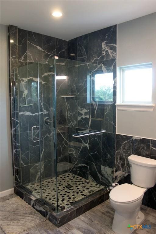2805 Tumbleweed Trl, Dale, TX 78616 - full bathroom featuring a stall shower, tile walls, and wood finished floors
