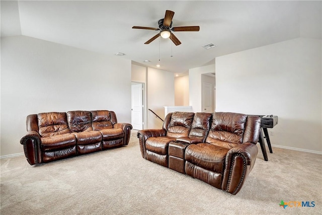 carpeted living room with ceiling fan and lofted ceiling