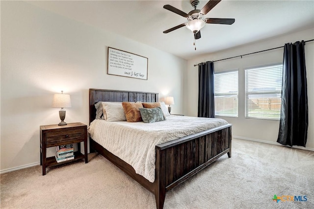 bedroom with ceiling fan and light colored carpet