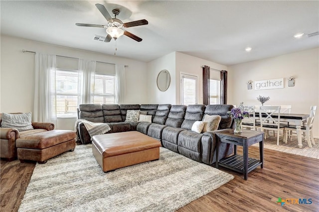 living room featuring hardwood / wood-style flooring and ceiling fan