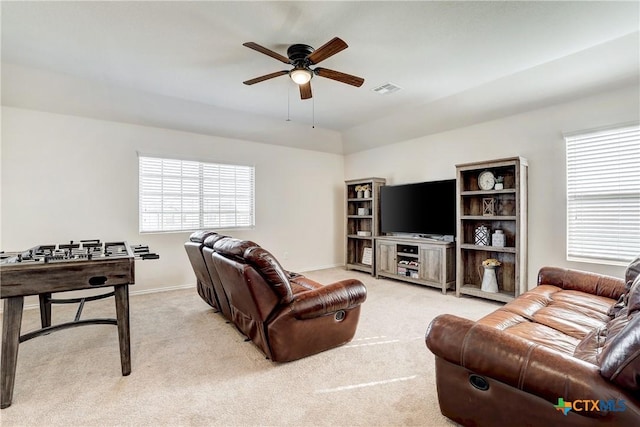 carpeted living room with vaulted ceiling and ceiling fan