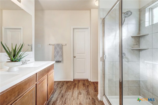 bathroom featuring vanity, hardwood / wood-style floors, and walk in shower