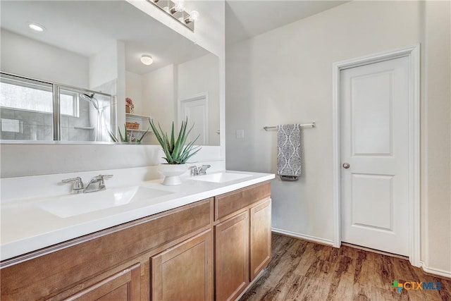 bathroom featuring vanity, hardwood / wood-style floors, and walk in shower