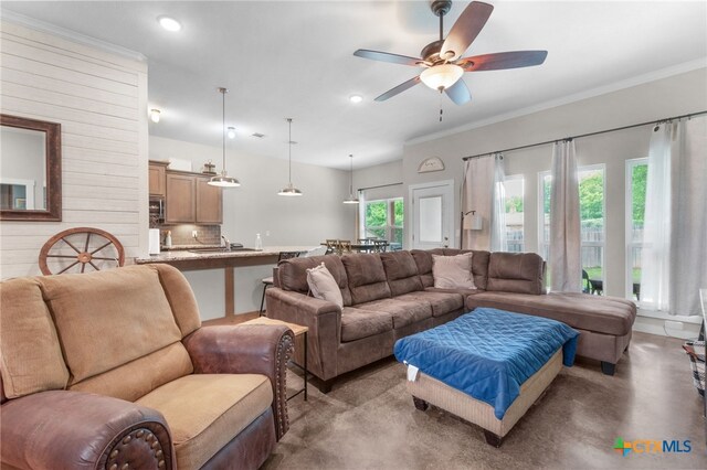 living area featuring crown molding, recessed lighting, ceiling fan, and concrete flooring