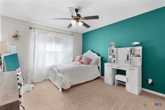 bedroom featuring ceiling fan, light colored carpet, and baseboards