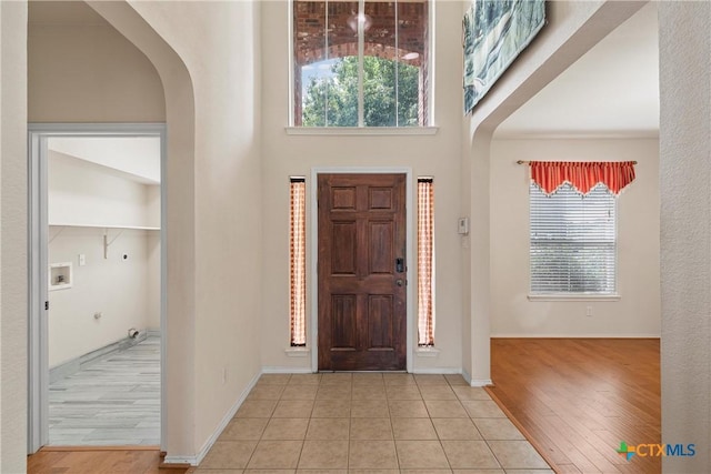125 Big Timber Dr, Temple, TX 76502 - entrance foyer with arched walkways, wood finished floors, and a high ceiling