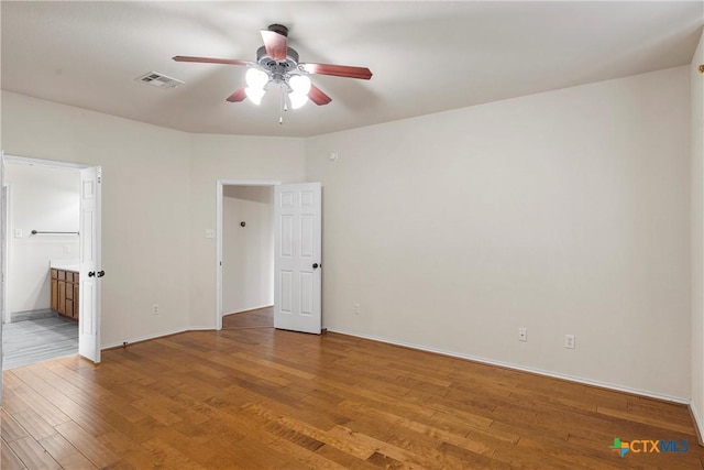 125 Big Timber Dr, Temple, TX 76502 - unfurnished bedroom with light wood-style flooring, connected bathroom, and a ceiling fan