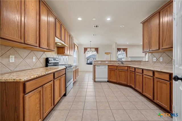 125 Big Timber Dr, Temple, TX 76502 - kitchen with electric stove, white dishwasher, brown cabinets, tasteful backsplash, and a peninsula