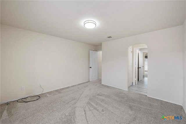 125 Big Timber Dr, Temple, TX 76502 - spare room featuring arched walkways and light carpet