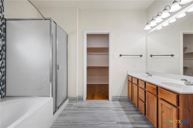 125 Big Timber Dr, Temple, TX 76502 - full bathroom featuring a stall shower, a spacious closet, a garden tub, and double vanity