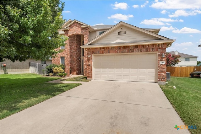 125 Big Timber Dr, Temple, TX 76502 - traditional home with concrete driveway, brick siding, and a garage
