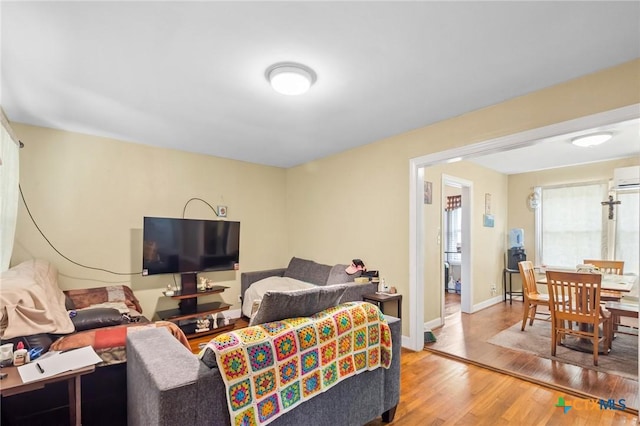 living area featuring baseboards and wood finished floors