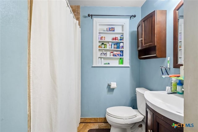 full bathroom featuring vanity, a shower with shower curtain, toilet, and tile patterned flooring