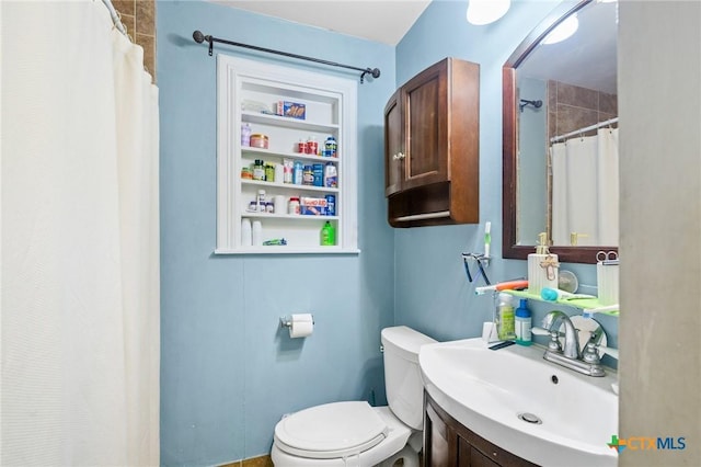 bathroom with a shower with shower curtain, toilet, and vanity