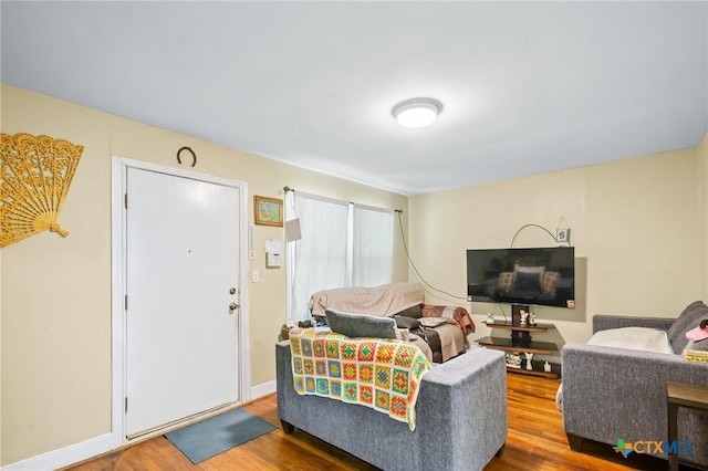 living room with baseboards and wood finished floors