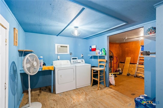 laundry room featuring washing machine and dryer and an AC wall unit