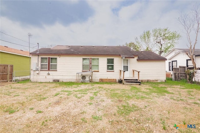 back of house with ac unit and fence