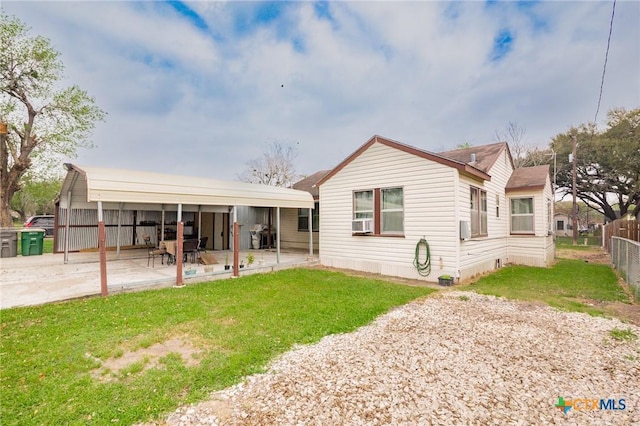 rear view of house featuring cooling unit, fence, and a lawn