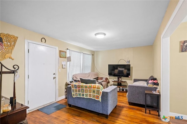 living room with baseboards and wood finished floors