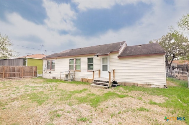 back of house featuring fence