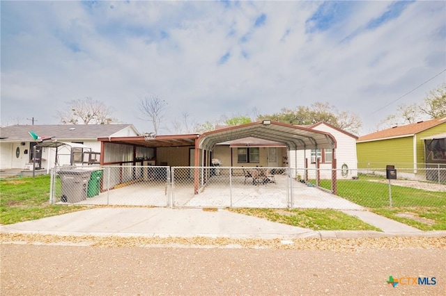 manufactured / mobile home featuring a detached carport, driveway, a gate, and fence