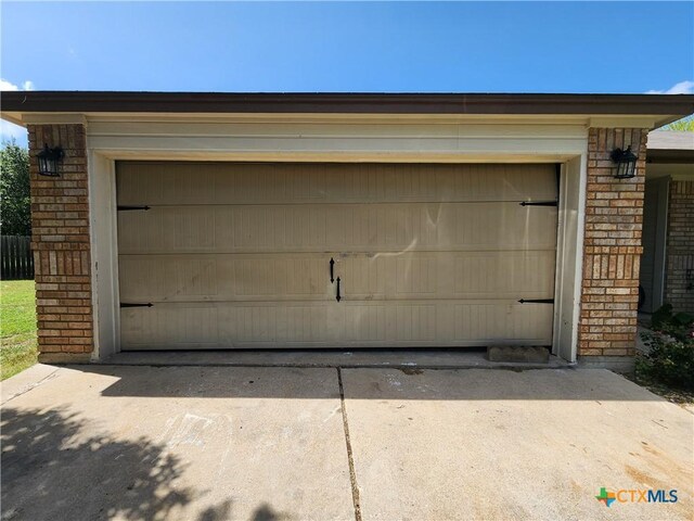 garage featuring concrete driveway