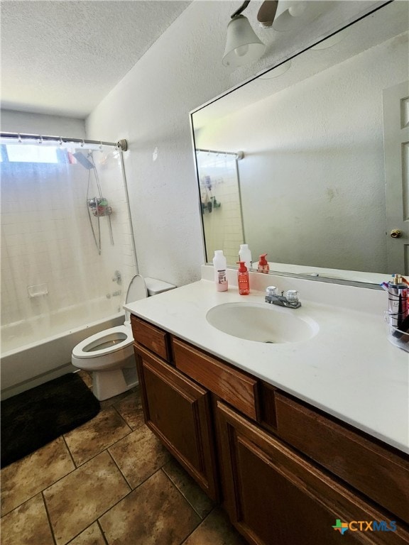 bathroom featuring shower / tub combo with curtain, vanity, and a textured ceiling