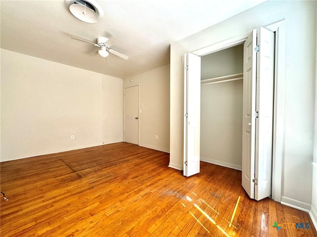 unfurnished bedroom featuring hardwood / wood-style flooring and ceiling fan