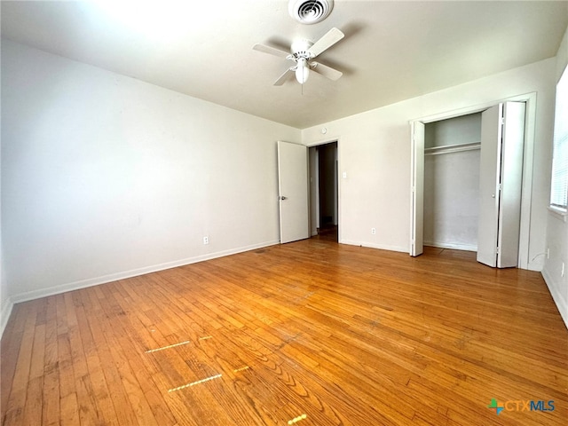 unfurnished bedroom featuring light hardwood / wood-style floors, ceiling fan, and a closet