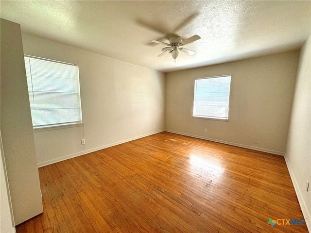 unfurnished room featuring light wood-type flooring, a textured ceiling, and ceiling fan