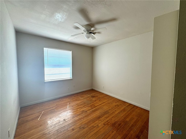 unfurnished room with wood-type flooring, ceiling fan, and a textured ceiling