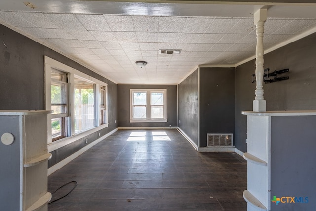 interior space featuring crown molding and dark wood-type flooring