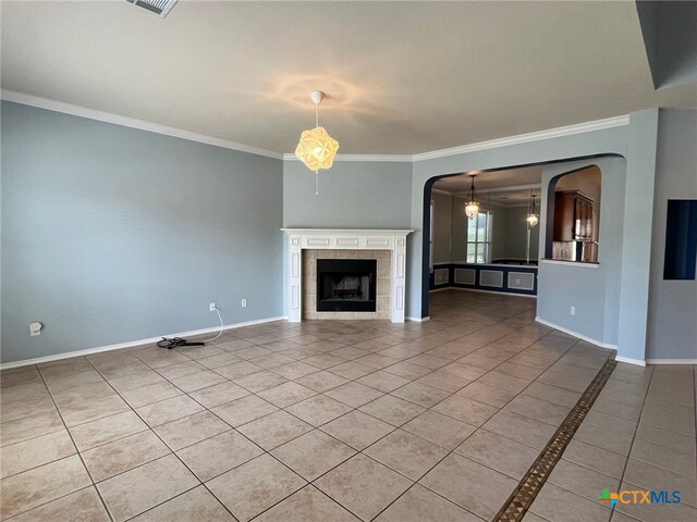 unfurnished living room with a fireplace, tile patterned floors, and ornamental molding