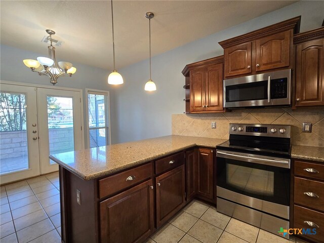 kitchen with kitchen peninsula, french doors, stainless steel appliances, decorative light fixtures, and an inviting chandelier