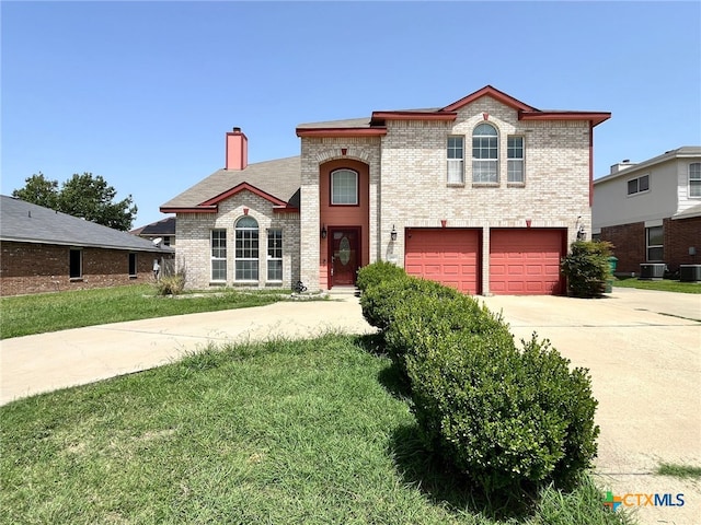 view of front facade featuring a garage and central AC