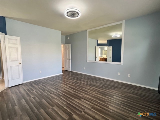 unfurnished room featuring dark wood-type flooring