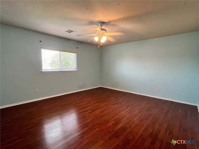 empty room featuring dark hardwood / wood-style floors and ceiling fan