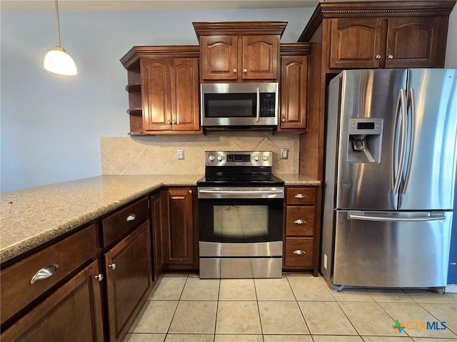 kitchen featuring light stone countertops, tasteful backsplash, pendant lighting, light tile patterned floors, and appliances with stainless steel finishes