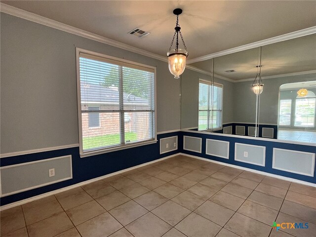 tiled spare room with ornamental molding